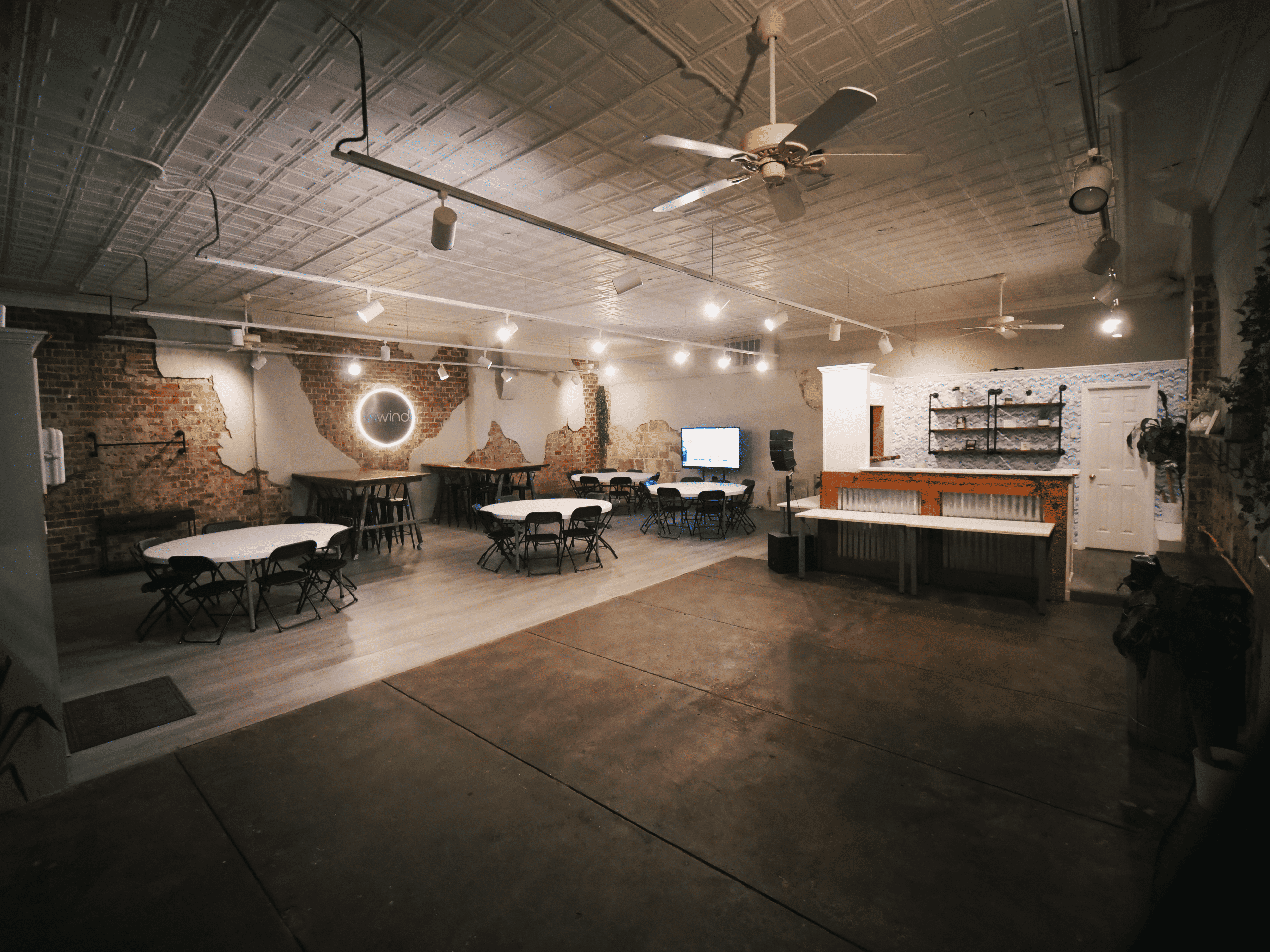 White tables and chairs with brick wall backdrop